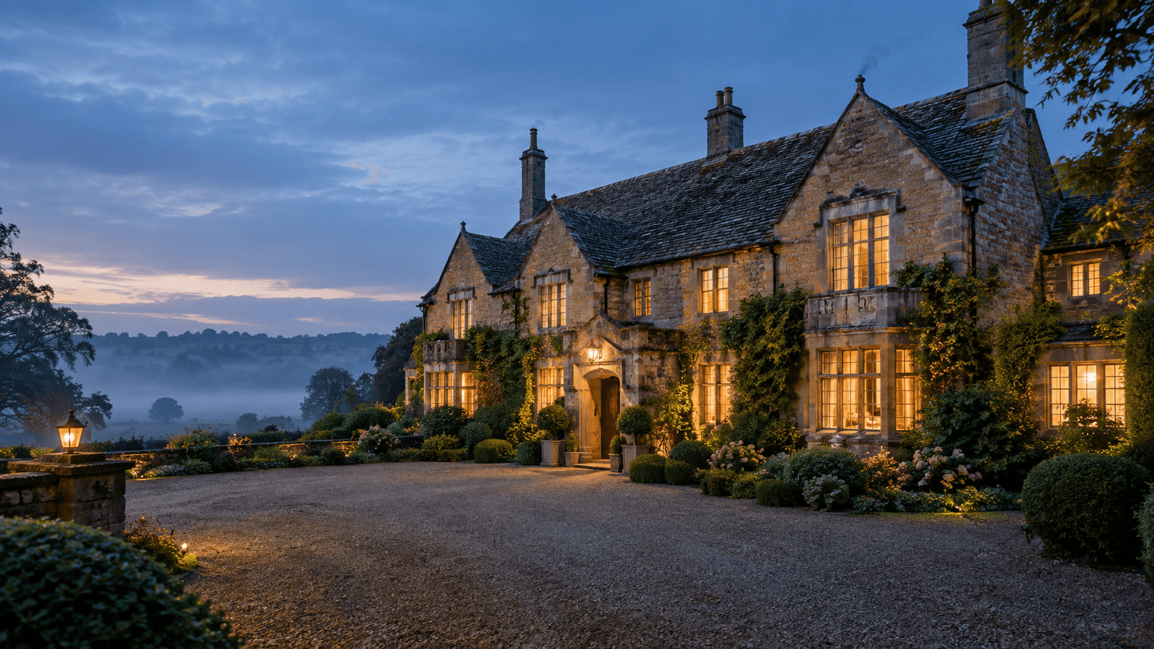 Stone country house at dusk with warm interior light